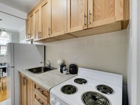 Toronto apartment for rent - a kitchen with white appliances and wood cabinets