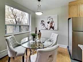 Toronto apartment for rent - a dining room with a glass table and chairs and a refrigerator