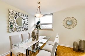 Toronto apartment for rent - A dining room with a glass table and chairs.