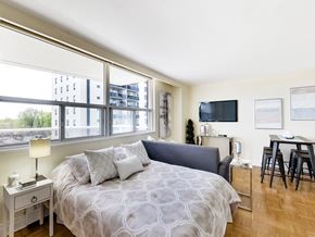 Toronto apartment for rent - A bedroom with a large bed and a flat screen TV mounted on the wall.