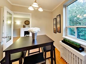 Toronto apartment for rent - a dining room with a table and chairs and a large window