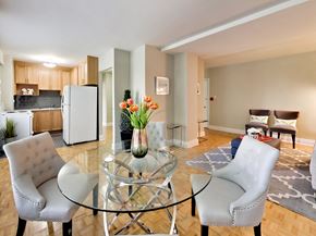 Toronto apartment for rent - a living room with a glass table and chairs and a kitchen