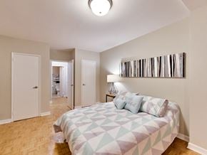 Toronto apartment for rent - a bedroom with a bed and a closet