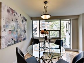 Toronto apartment for rent - a dining room with a glass table and chairs and a large window