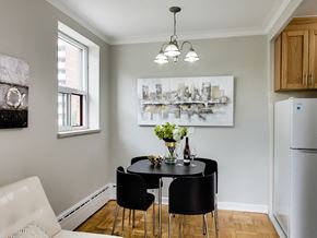 Toronto apartment for rent - a dining room with a black table and chairs and a refrigerator