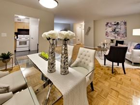 Toronto apartment for rent - a view of a living room and dining room with a table with three vases