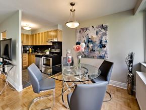 Toronto apartment for rent - a dining room with a glass table and chairs and a kitchen