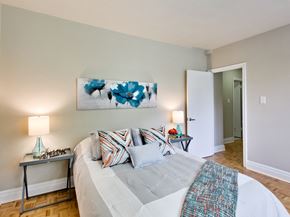 Toronto apartment for rent - a bedroom with a large bed and a painting on the wall