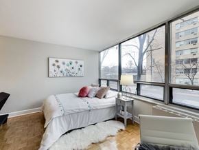 Toronto apartment for rent - A bedroom with a large bed and a painting on the wall.