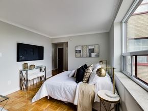 Toronto apartment for rent - a bedroom with a bed and a tv on the wall