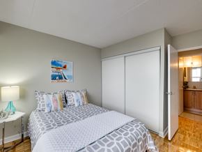 Mississauga apartment for rent - a bedroom with a bed and a mirrored wall