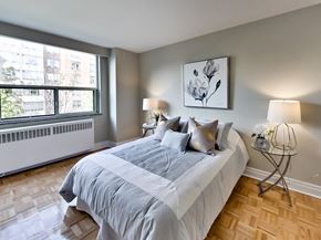 Toronto apartment for rent - a bedroom with a large bed and a window