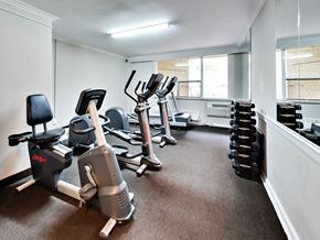 Toronto apartment for rent - a gym with cardio machines and weights on the floor