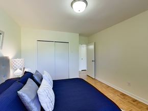 Toronto apartment for rent - a bedroom with a large blue bed and a closet