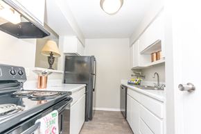 Dallas apartment for rent - a white kitchen with stainless steel appliances and white cabinets