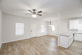 Springtown apartment for rent - an empty kitchen and living room with a ceiling fan