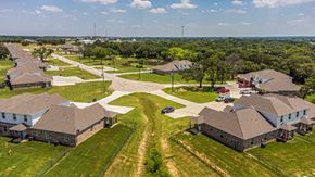 Springtown apartment for rent - an aerial view of a neighborhood of houses with cars and trees