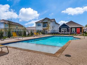 Fort Worth apartment for rent - a swimming pool with houses in the background