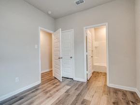 Fort Worth apartment for rent - a bedroom with two closets and a door to a bathroom