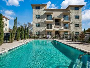 Richardson apartment for rent - a large swimming pool in front of a building