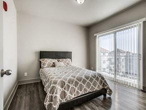 Richardson apartment for rent - a bedroom with a large window and a bed