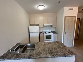 Kingston apartment for rent - A kitchen with granite countertops and white appliances.