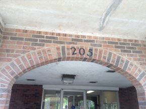 Kingston apartment for rent - A brick archway with the number 205 painted on it.