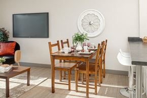 Kingston apartment for rent - A dining room with a wooden table and chairs.