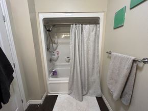 Kingston apartment for rent - A bathroom with a white shower curtain and a white rug.