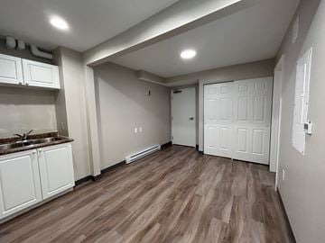 Kingston apartment for rent - A kitchen with white cabinets and a sink.