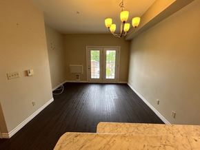 Kingston apartment for rent - A room with a chandelier, a window, and a door leading outside.
