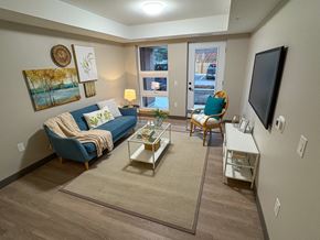 Kingston apartment for rent - A living room with a blue couch, a coffee table, and a flat screen TV.