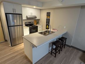 Kingston apartment for rent - A kitchen with a stainless steel refrigerator and a white countertop.