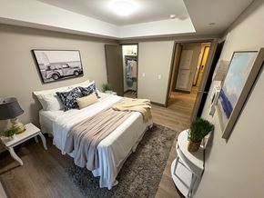 Kingston apartment for rent - A bedroom with a bed, nightstand, and lamp.