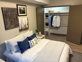 Kingston apartment for rent - A bedroom with a white bed and a city map on the wall.