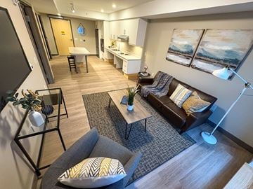 Kingston apartment for rent - A living room with a grey couch and a coffee table.