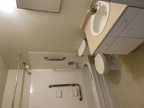 Kingston apartment for rent - A white bathroom with a toilet and a shower.