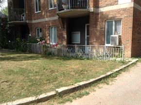 Kingston apartment for rent - A brick building with a balcony and a metal railing.