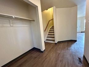 Kingston townhouse for rent - an empty room with a staircase and a white wall