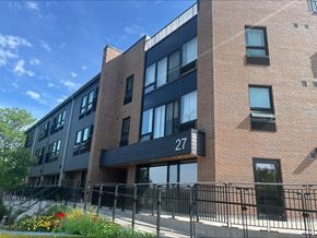Kingston apartment for rent - a brick apartment building with a black railing and a gate