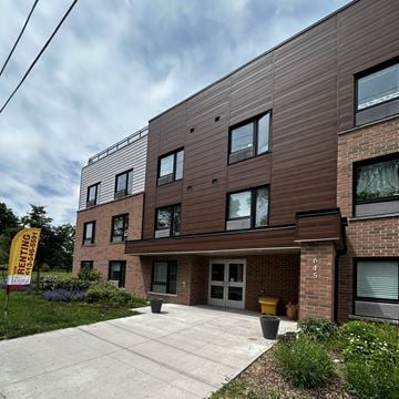 Kingston apartment for rent - A building with a sign that says "RENTING" in front of it.