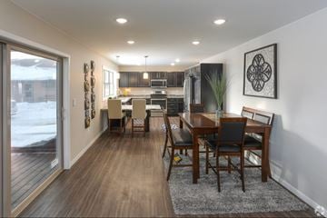 Grand Forks apartment for rent - A modern dining room with a wooden table and chairs.