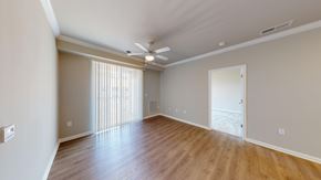 Virginia Beach apartment for rent - A room with wooden floors and a ceiling fan.