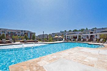 Resort-style pool with fountains and multiple cabanas