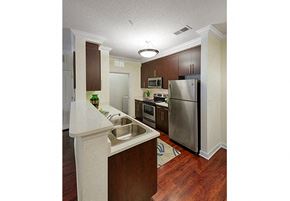 Raleigh apartment for rent - Kitchen with stainless steel appliances; door to laundry area