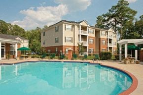 Yorktown apartment for rent - Pool with pergola, chairs and umbrellas; apartment building