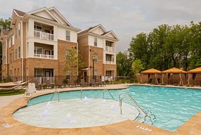 Charlotte apartment for rent - Charlotte, North Carolina, Luxury Apartments with In-Unit Washer and Dryer - Belmont at Tryon - Swimming Pool With Shallow Splash Area, Lounge Chairs, And Cabana Seating.
