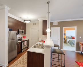 Richmond apartment for rent - Apartments Near University of Richmond, VA - Clairmont at Chesterfield - Kitchen With Breakfast Bar, Double Sink, Dark Cabinets, Stainless Steel Appliances, and Pendant Lights Over Counter Seating.
