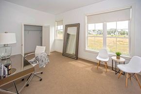 Buffalo apartment for rent - A room with a brown carpet and white chairs.