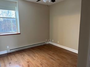 Buffalo apartment for rent - A room with wooden flooring and a window.